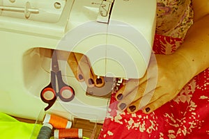 Processes of sewing on the sewing machine sew women`s hands sewi