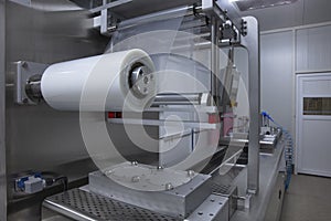 Processing of Packaging of butter and Cheese on food vacuum packaging sealing machine in food industrial factory. Packing food