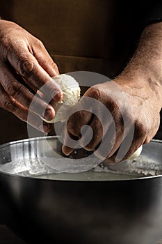 The processing Traditional Italian mozzarella, Cheesemaker, showing freshly made mozzarella