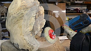 processing wood with a sander in a carpenter's workshop