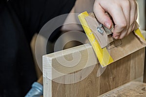 Processing wood with a sanding block - carpenter