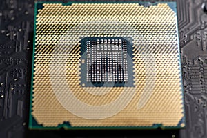 Processor on computer hardware. Circuit board in close-up background with processor chip. Circuit board for computing electronics