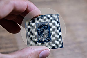 The processor is a desktop computer in hand. Inspect the CPU contacts before installing