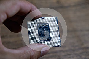 The processor is a desktop computer in hand. Inspect the CPU contacts before installing