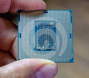 The processor is a desktop computer in hand. Inspect the CPU contacts before installing