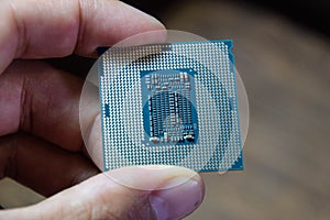 The processor is a desktop computer in hand. Inspect the CPU contacts before installing