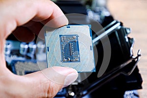 The processor is a desktop computer in hand. Inspect the CPU contacts before installing