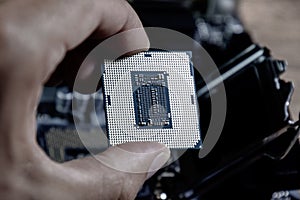 The processor is a desktop computer in hand. Inspect the CPU contacts before installing