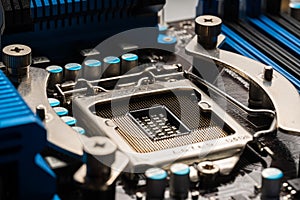 Processor socket on motherboard computer motherboard with blue heatsinks and capacitors