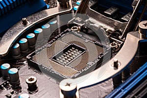 Processor socket on motherboard computer motherboard with blue heatsinks and capacitors