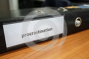 procrastination concept.procrastinating problem. written word at paper note stick. office paperwork stuff around it