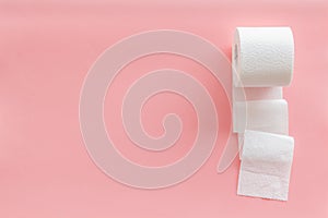 Proctology concept with toilet paper on pink background top view space for text