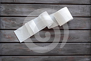 Proctology concept with toilet paper on wooden background top view