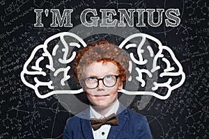 Prodigy child boy with curly ginger hair in glasses. Genius kid