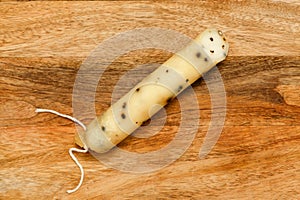 Produce of Spain - stick of hard goat cheese with whole plack peppercorns