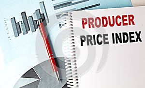 PRODUCER PRICE INDEX text on a notebook with pen on a chart background