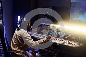 Producer working on music keyboard in the studio