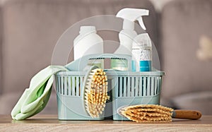 Product, basket and cleaning with a brush, supplies or detergent on a wooden table surface for housework. Bacteria