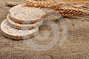 Product made from wheat, expanded and ears wheat on o jute background. Healthy organic food. Selectiv focus. Copy space