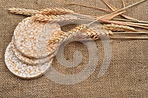 Product made from wheat, expanded and ears wheat on o jute background. Healthy organic food. Selectiv focus. Copy space