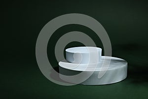 Product photography props. Round shaped podiums on green background, space for text