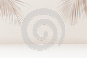 Product placement background with palm leaves shadow on beige cement wall texture