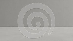 Minimalist studio background with a smooth grey concrete wall and a textured grey floor for product display