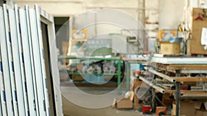 The production of assembly and manufacturing of PVC windows, a workshop with finished products, in the background, a