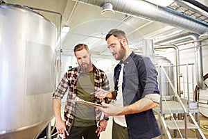 Men with clipboard at brewery or beer plant