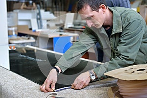 Production of cabinet furniture Small-Sized Companies and people concept. young man working at the furniture production. assembly