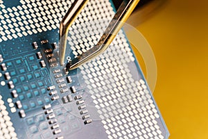 production of central processing units, tweezers working over a a cpu.
