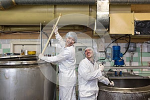 Production of cheese in dairy, two worker