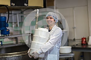 Production of cheese in dairy, worker with forms