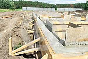 Production of the concrete base under the house with use of a removable timbering. photo