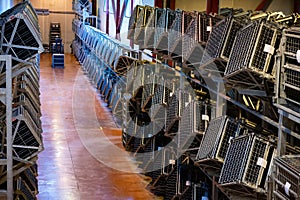 Production of cremant sparkling wine in Burgundy, France. Automatically powered riddling remuage boxes on factory