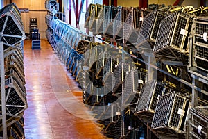 Production of cremant sparkling wine in Burgundy, France. Automatically powered riddling remuage boxes on factory