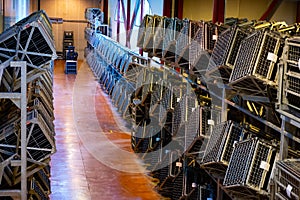 Production of cremant sparkling wine in Burgundy, France. Automatically powered riddling remuage boxes on factory