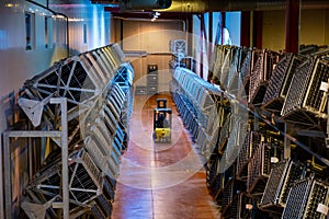 Production of cremant sparkling wine in Burgundy, France. Automatically powered riddling remuage boxes on factory