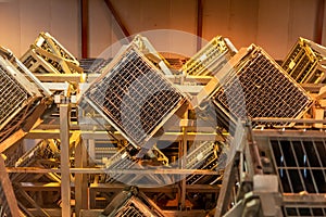 Production of cremant sparkling wine in Burgundy, France. Automatically powered riddling remuage boxes on factory