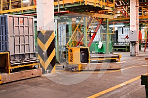 Production department at a petrochemical, oil refinery with ceilings, pipes, self-moving trolleys for the carriage of goods