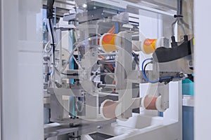 Production of empty plastic cups - injection molding machine during work