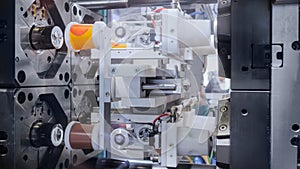 Production of empty plastic cups - injection molding machine during work