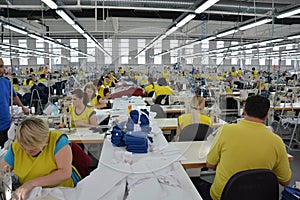 Production hall with workers in a textile industrial company