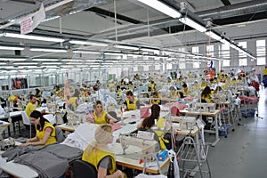 Production hall with workers in a textile industrial company