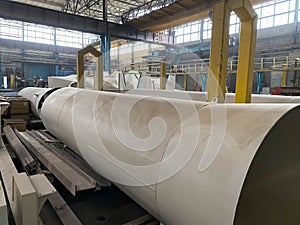 Production of large diameter steel pipes at a metallurgical plant. Soft focus. Close-up