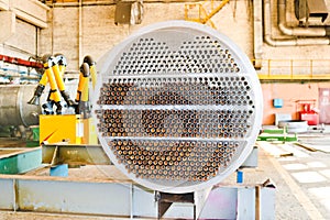 Production of a large tube bundle for a shell-and-tube heat exchanger in an industrial production room of a shop with equipment