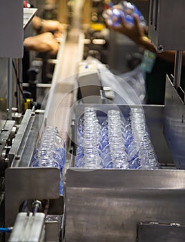 Production line collecting empty plastic bottle from blowing machine
