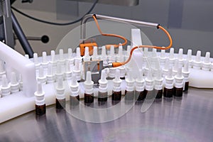 The production line of the medicine. Filling interferon in bottl