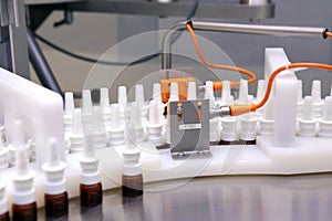The production line of the medicine. Filling interferon in bottl photo