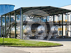 Production of liquefied carbon dioxide of carbonic acid part of chemical plant three cryogenic tanks with CO2 under canopy that